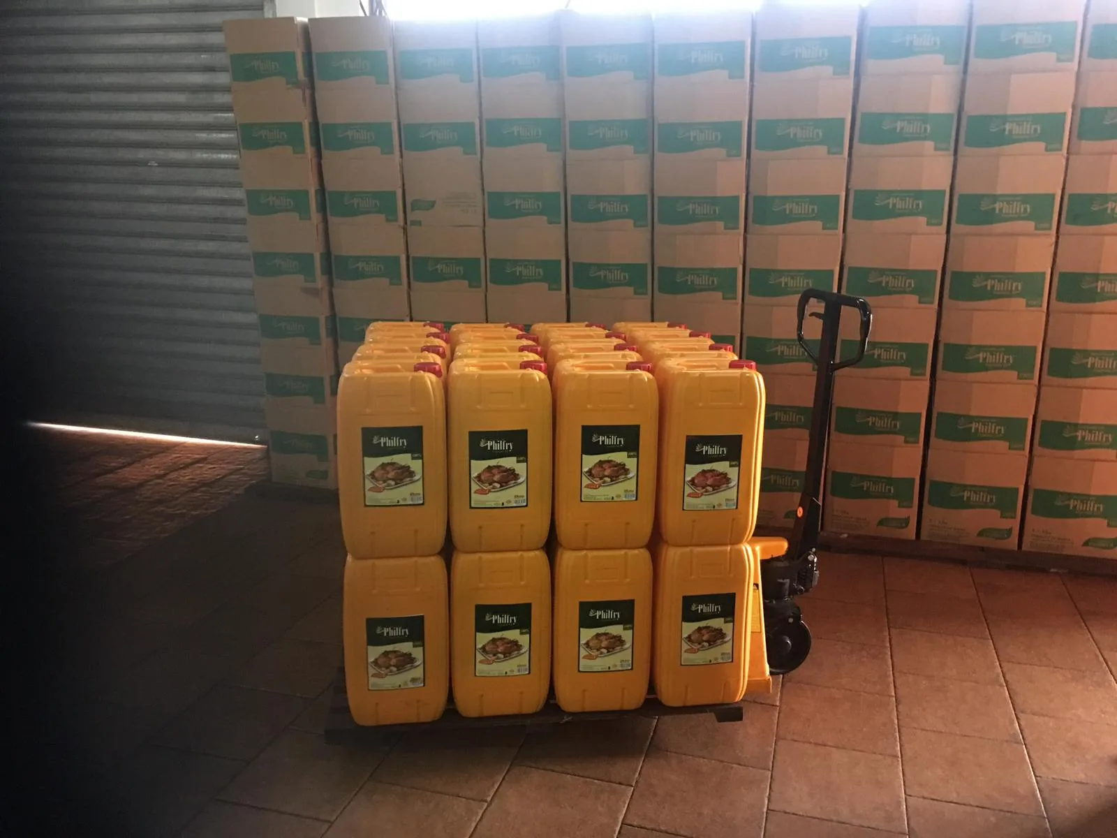 Branded Philfry oil jerry cans stacked on a pallet ready for dispatch