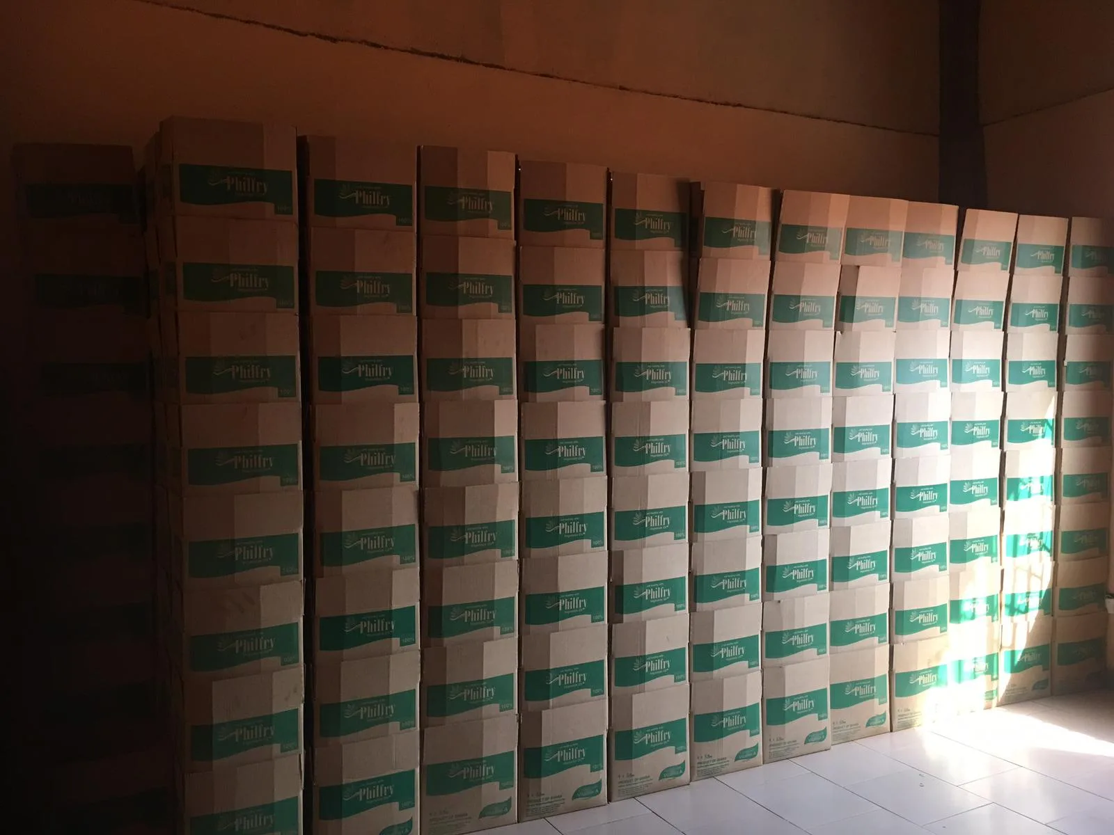 Wall of stacked Philfry vegetable oil cartons stored inside the Oyarifa warehouse